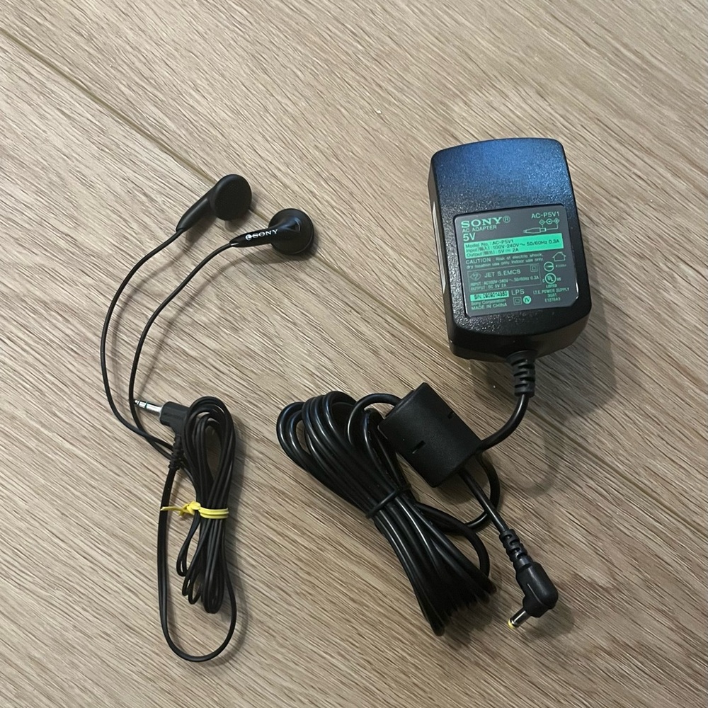 SONY Black Earbuds and SONY AC Adapter